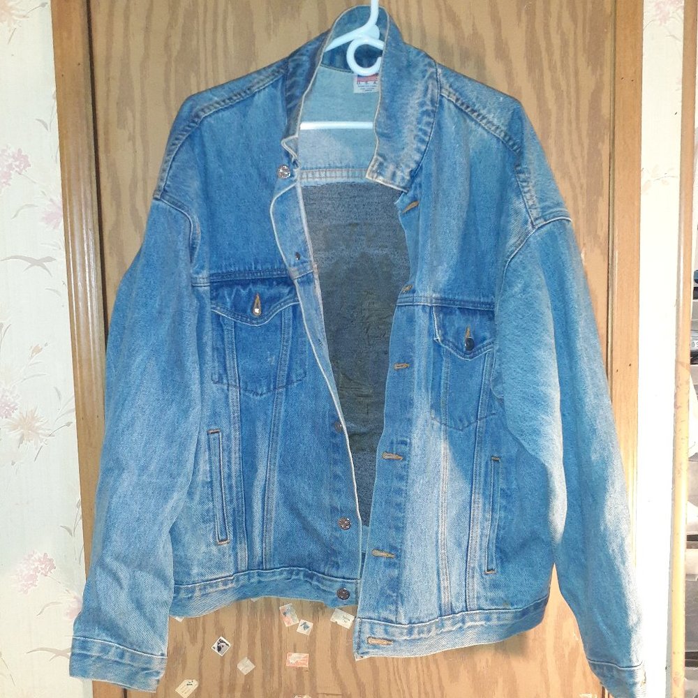 A JEAN JACKET WITH AN INDIAN ON THE BACK